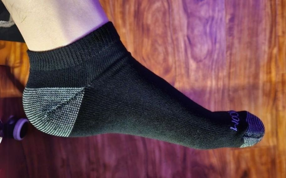 a mans foot in a black low cut ankle sock