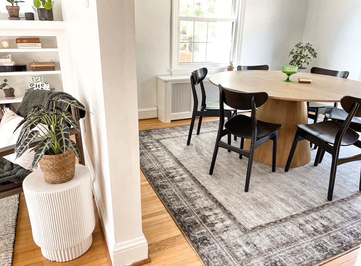 view of living room and dining room with arched doorway and white walls