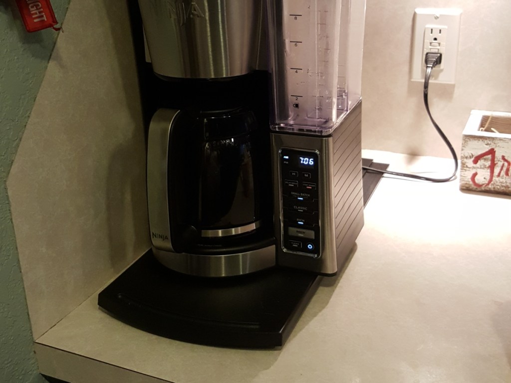 coffee maker sitting on sliding tray