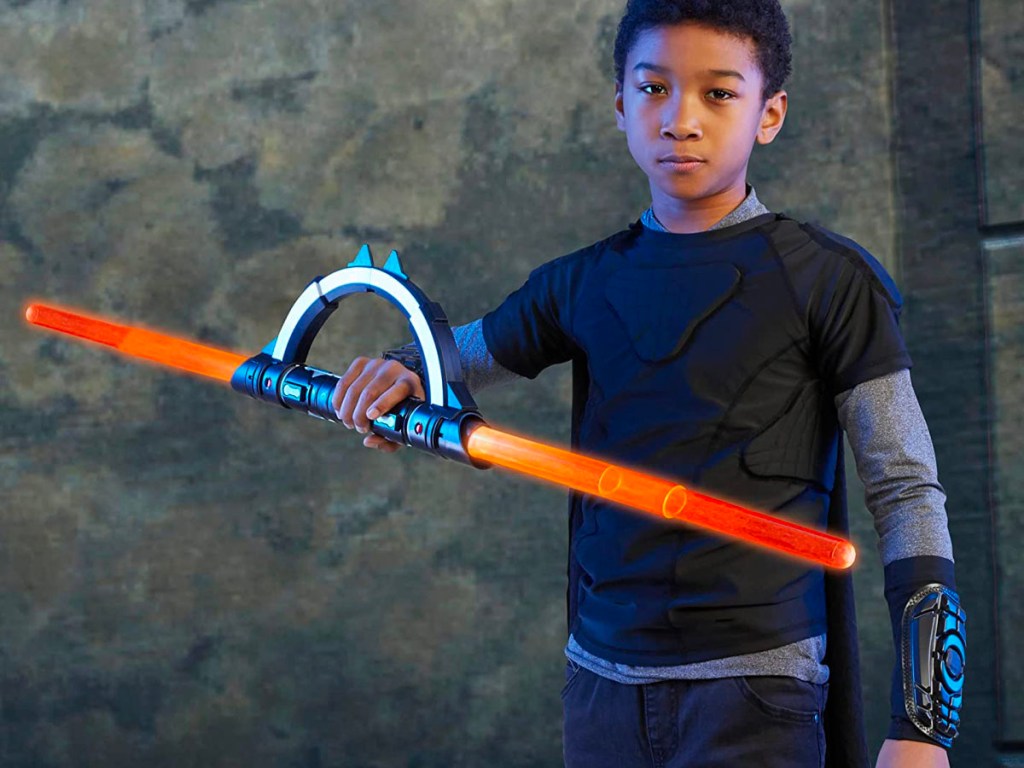 child playing wtih star wars lightsaber