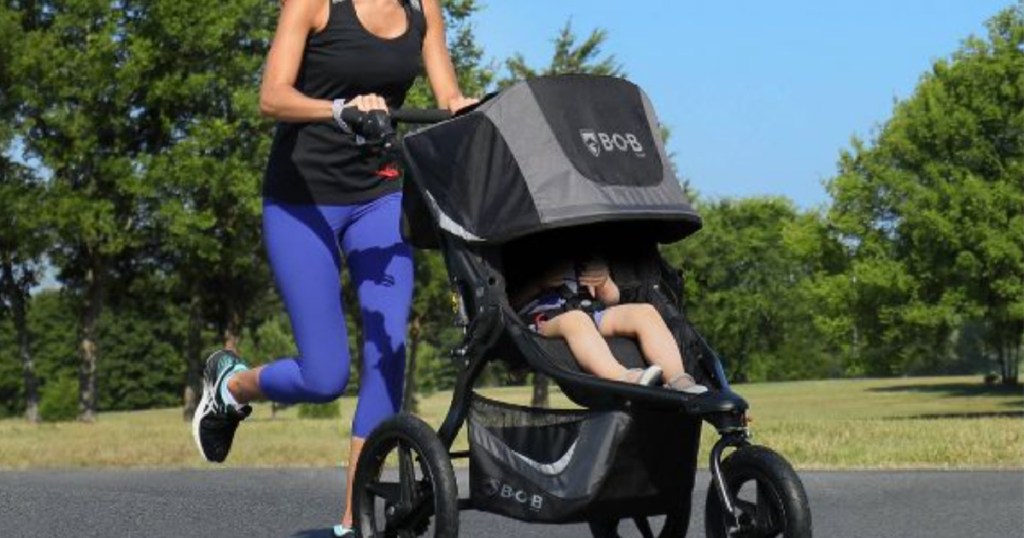 woman running with black stroller 