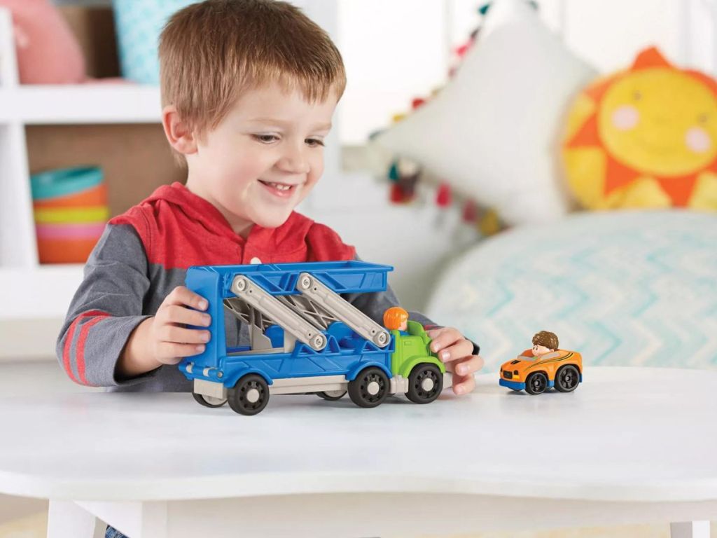 kid playing with fisher price little people truck