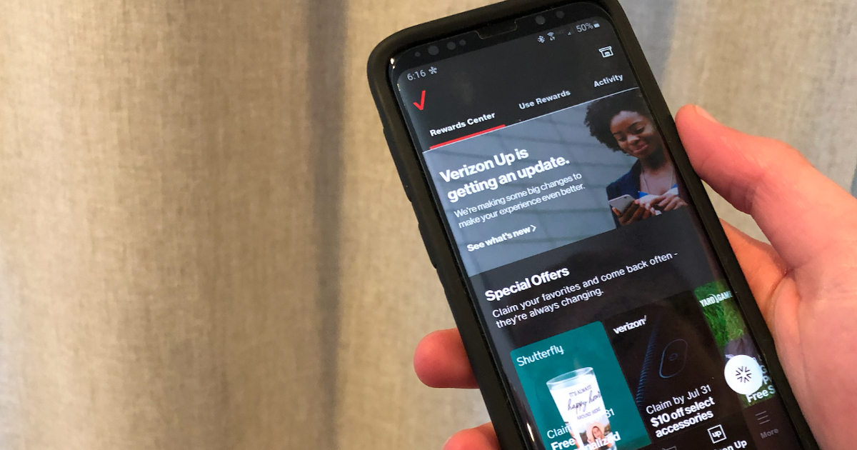 Hand holding phone with Verizon Up Rewards app