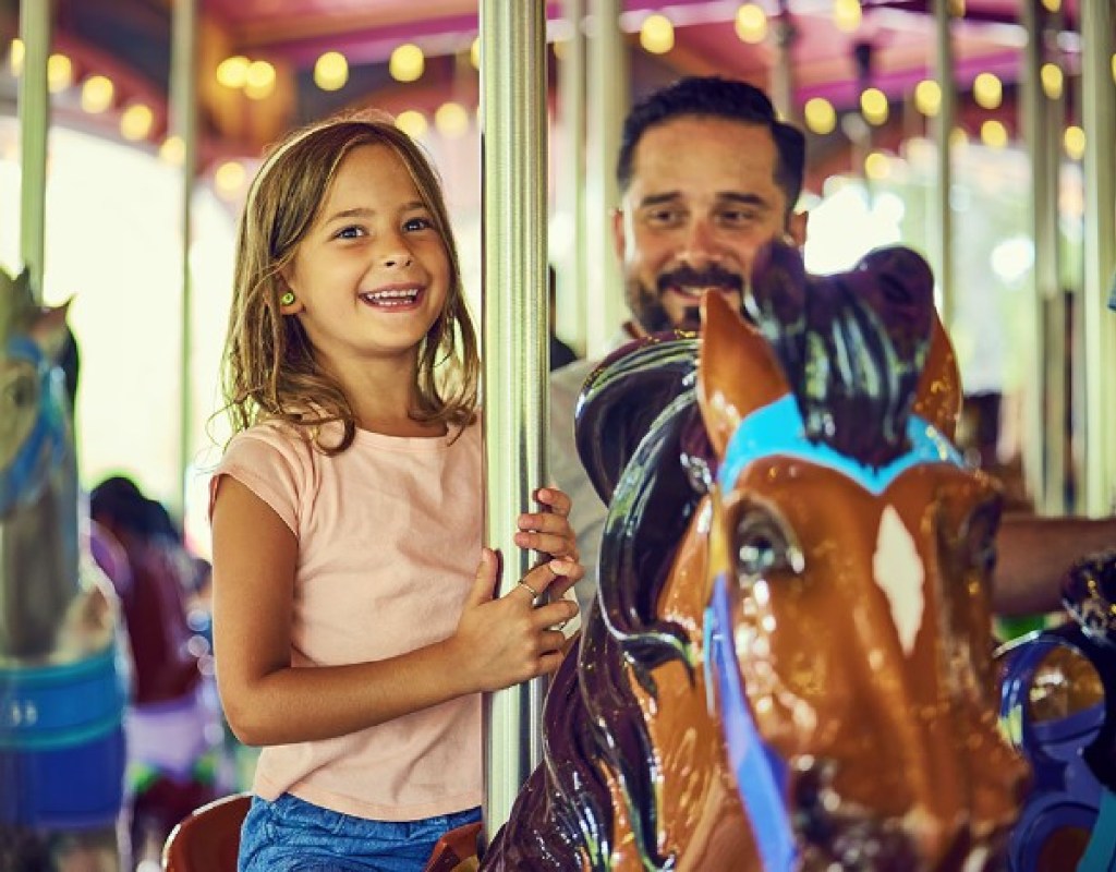 A girl and her dad on the Kings Dominion Carousel ride