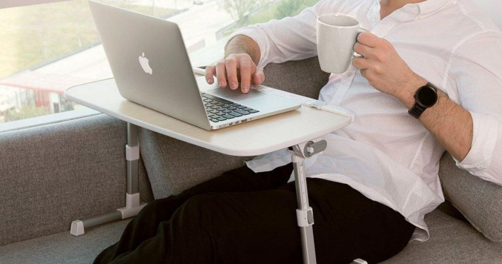 man using Taotronics Laptop Desk on couch