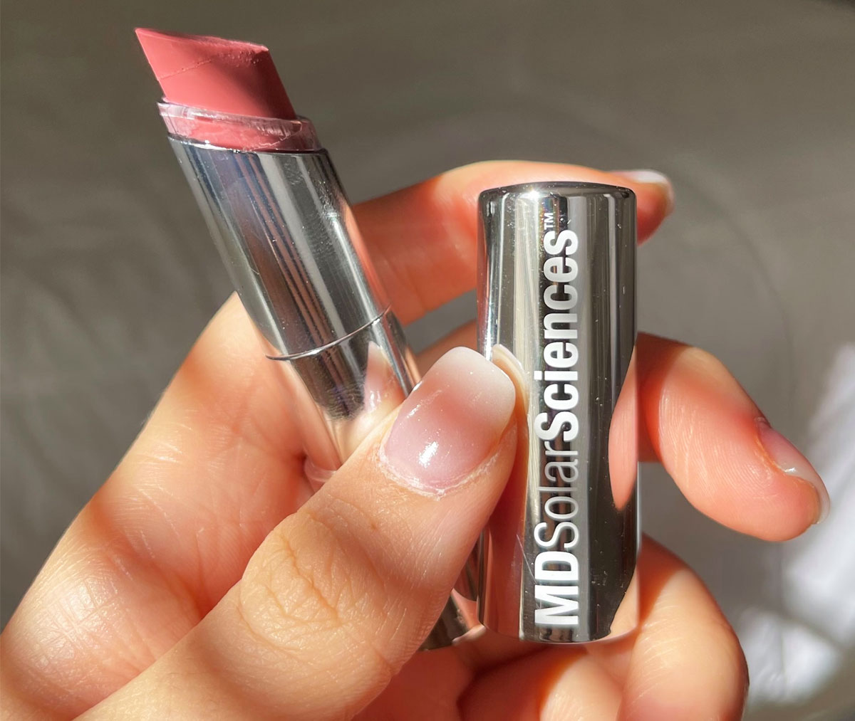 hands holding MDSolarSciences Tinted Lip Balm