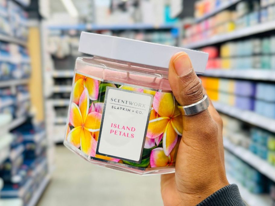 Hand holding a Scentworx Candle in Island Petals Scent