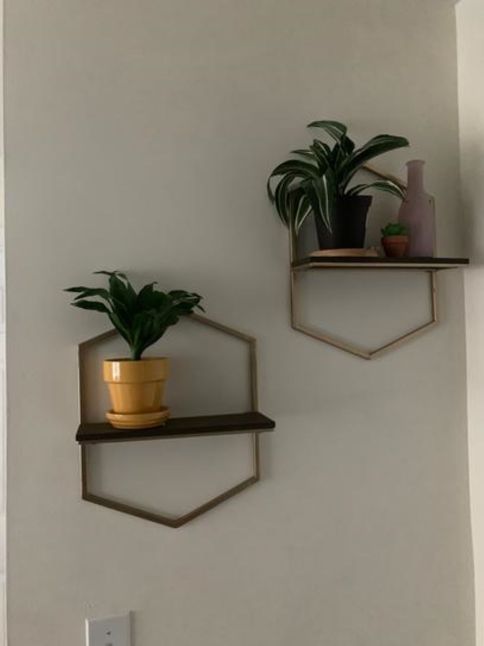 Two floating shelves hanging on a wall