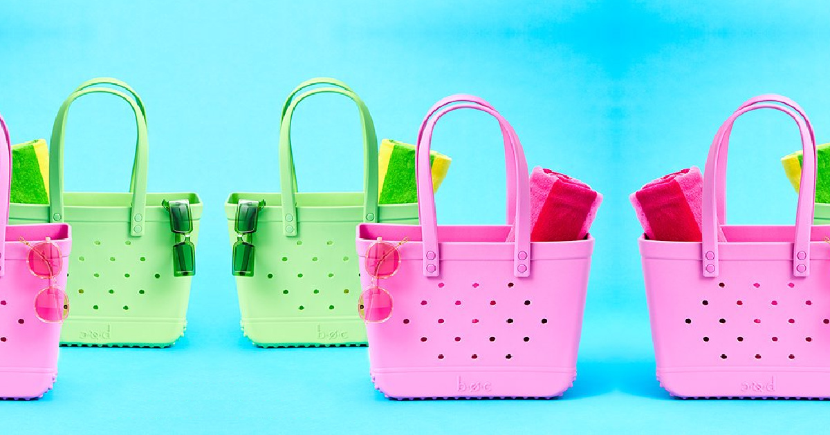pink and green tote bags filled with beach towels and sunglasses