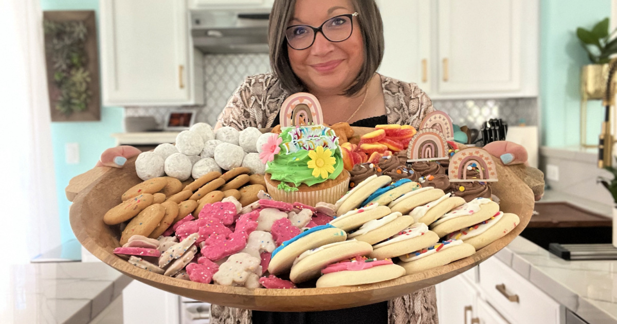 woman holding a platter of treats