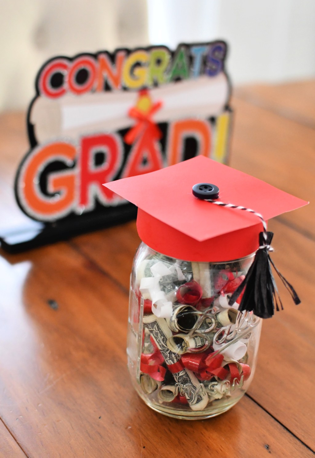 congrats grad sign and jar gift on a table