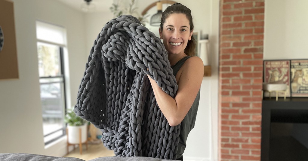 woman holding bearaby weighted blanket