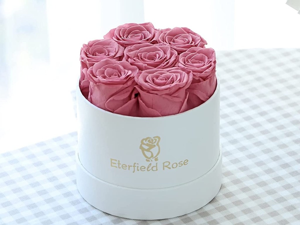 7 pink roses in a white box