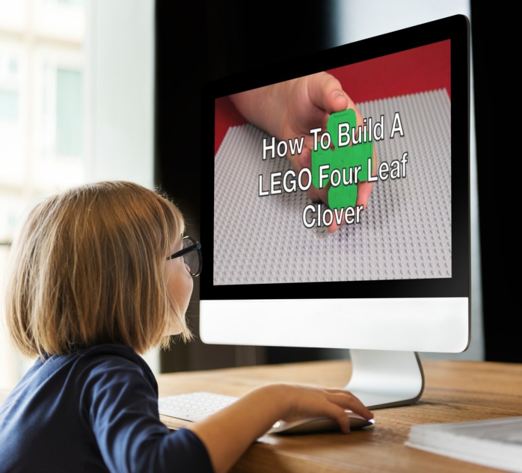 child looking at LEGO instructions on an iMac