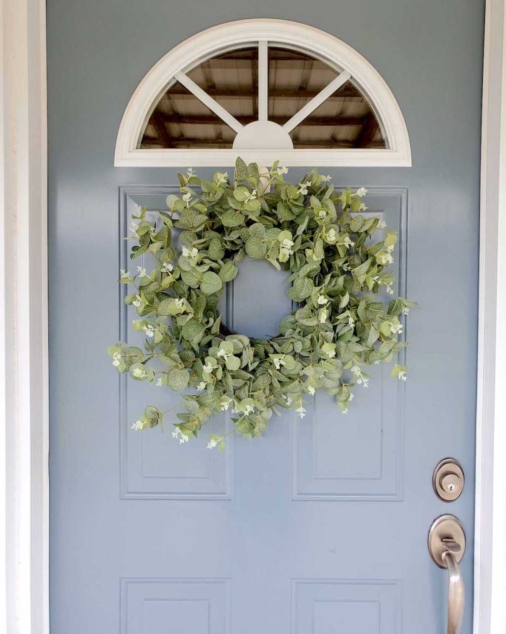 blue front door with eucalyptus wreath on front