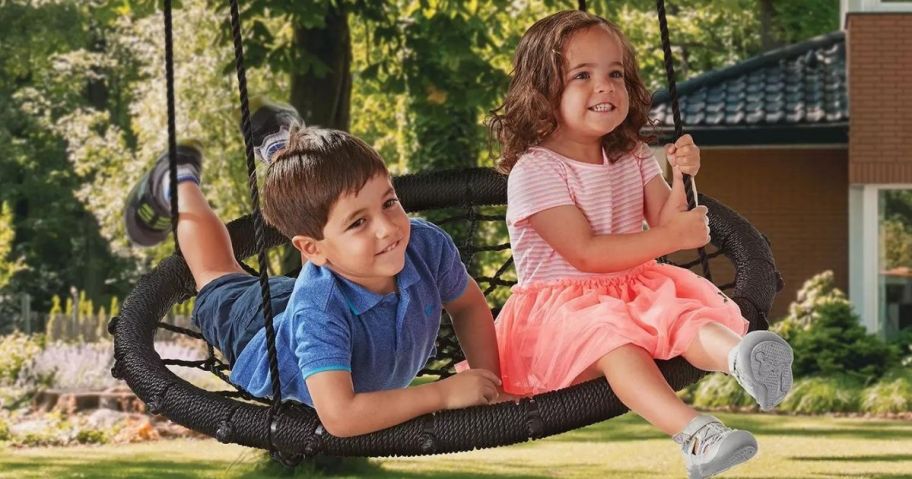 two kids on nest swing