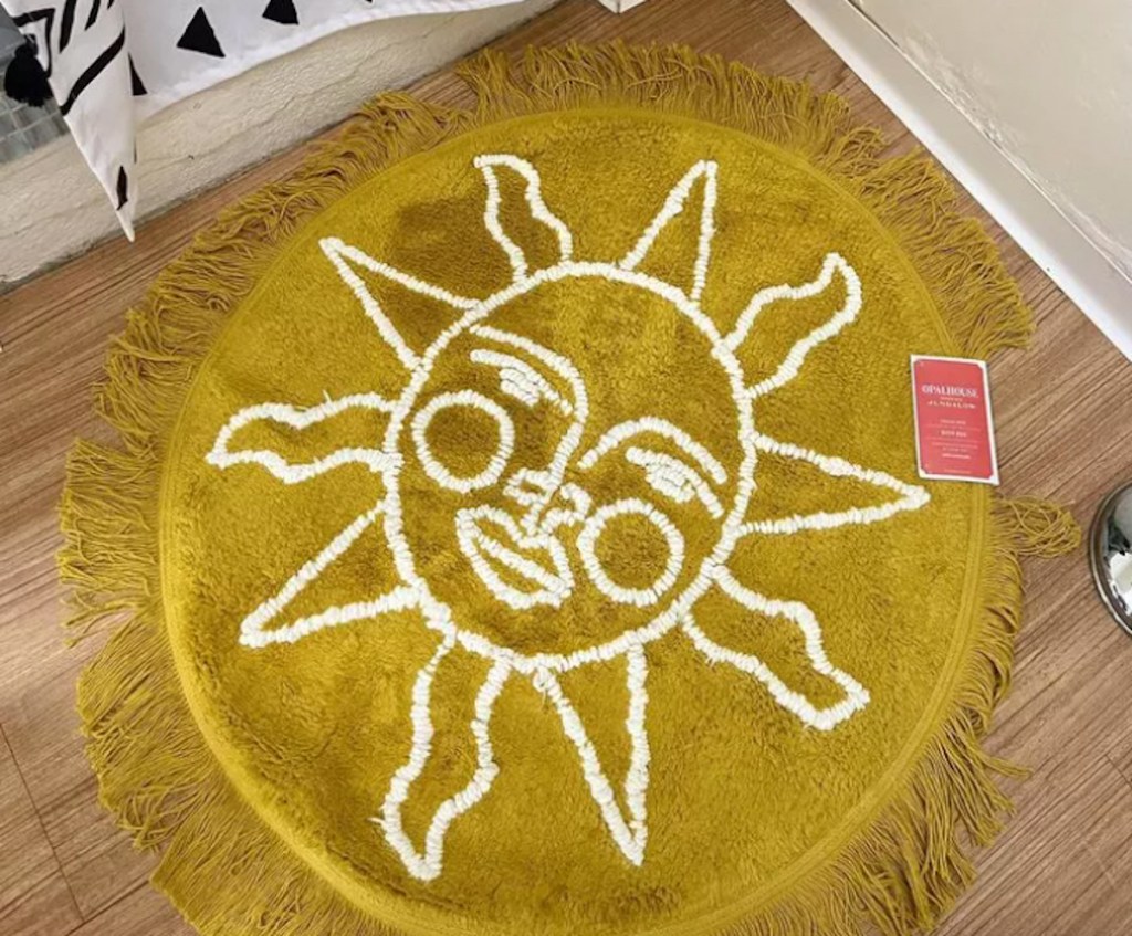 yellow fringe sunshine rug on wood floor with jungalow tag