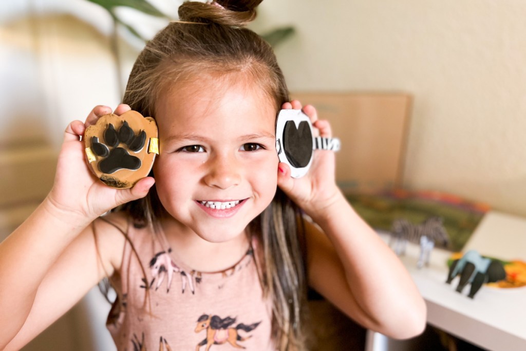 girl holding up stamps