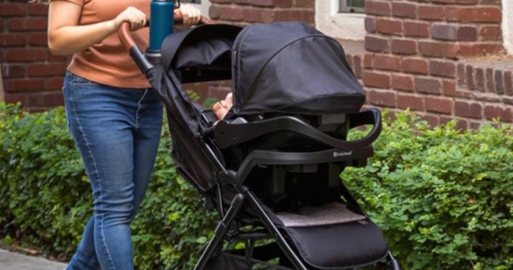 woman pushing black stroller