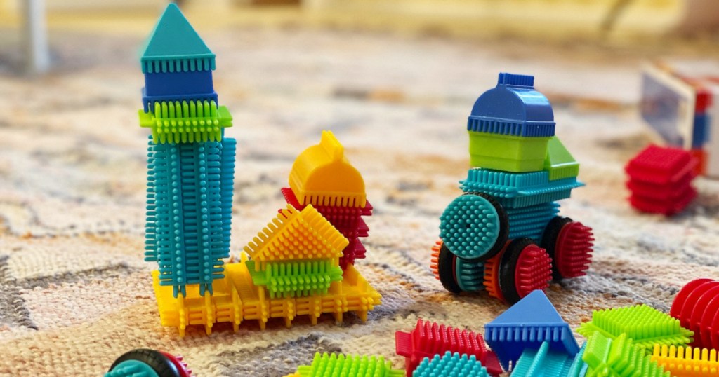 Bristle Blocks on floor arranged into designs