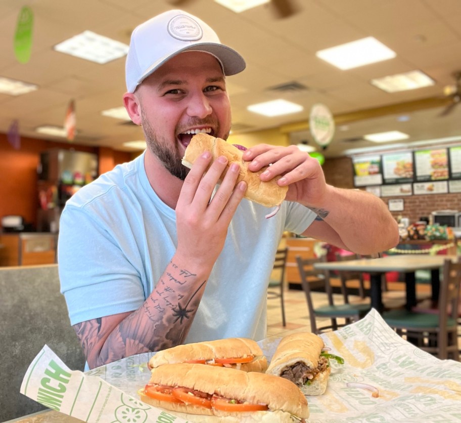 Happy man ready to take bite out of subway sandwhich