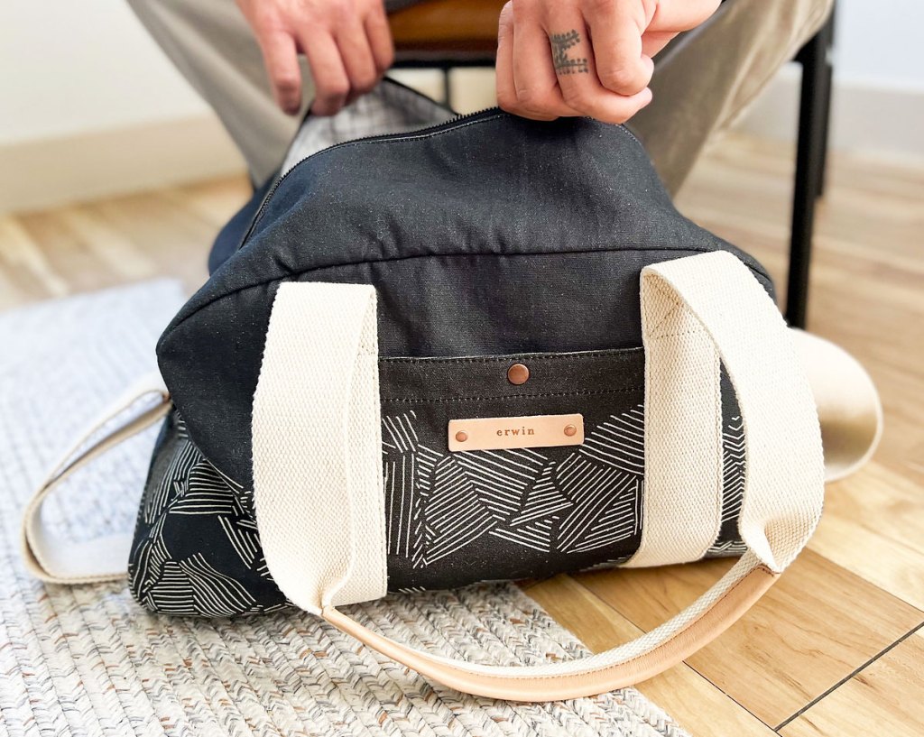 zippering up minted weekender bag