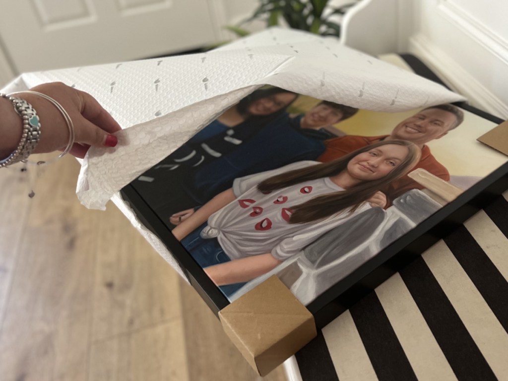 woman unboxing handpainted family portrait