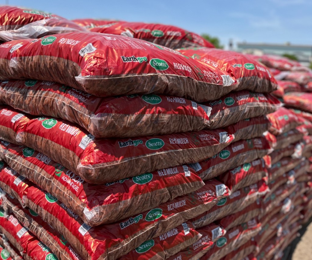 bags of red mulch in a pile