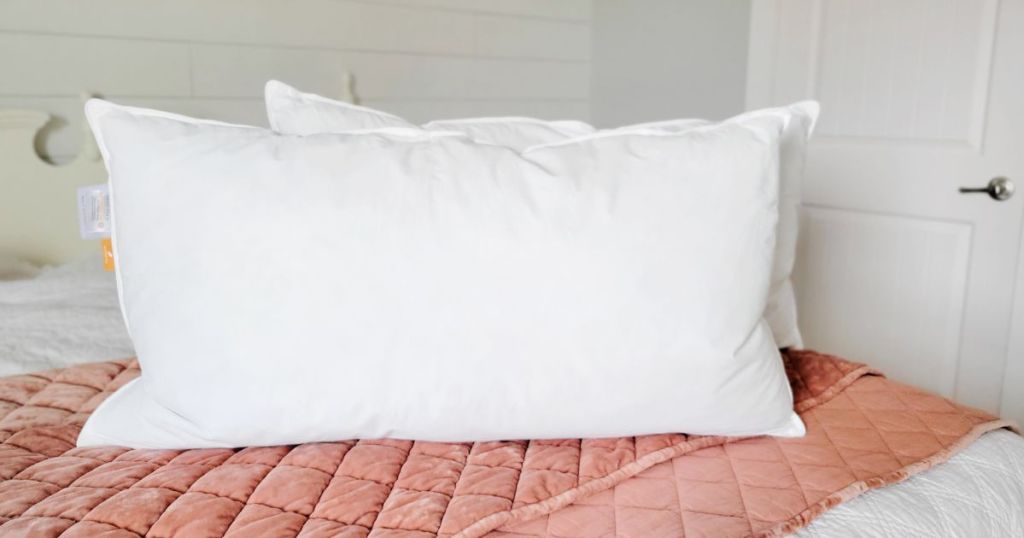 Warmkiss pillows on a bed