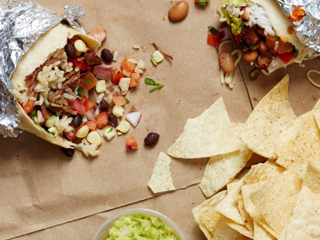 foil-wrapped burrito next to tortilla chips