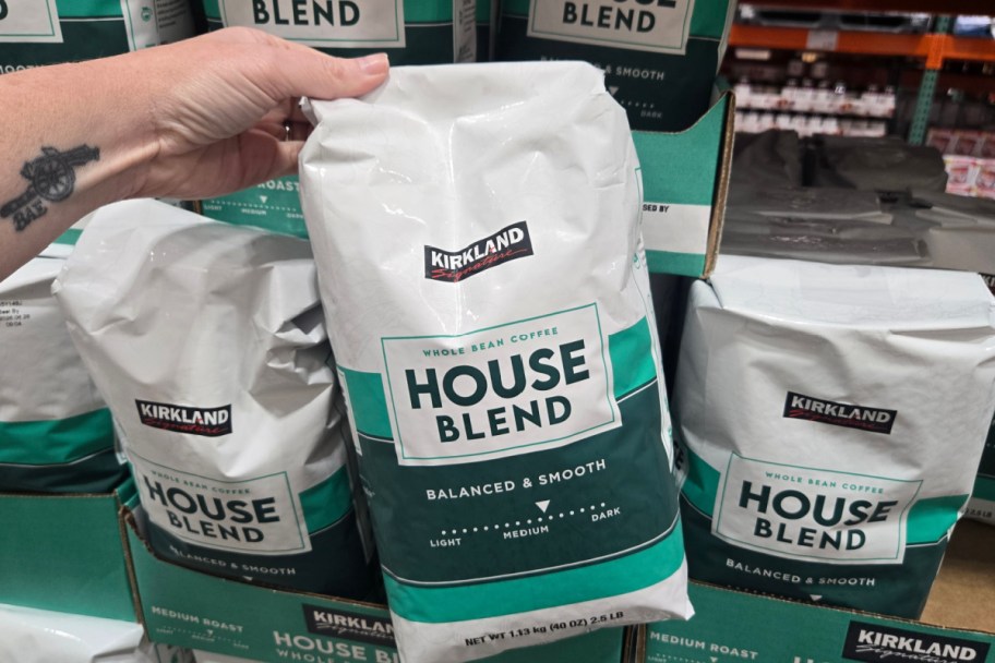 hand holding large bag of coffee