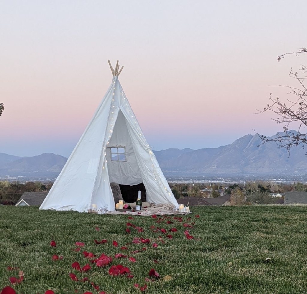 cotton teepee engagement photo shoot with mountains