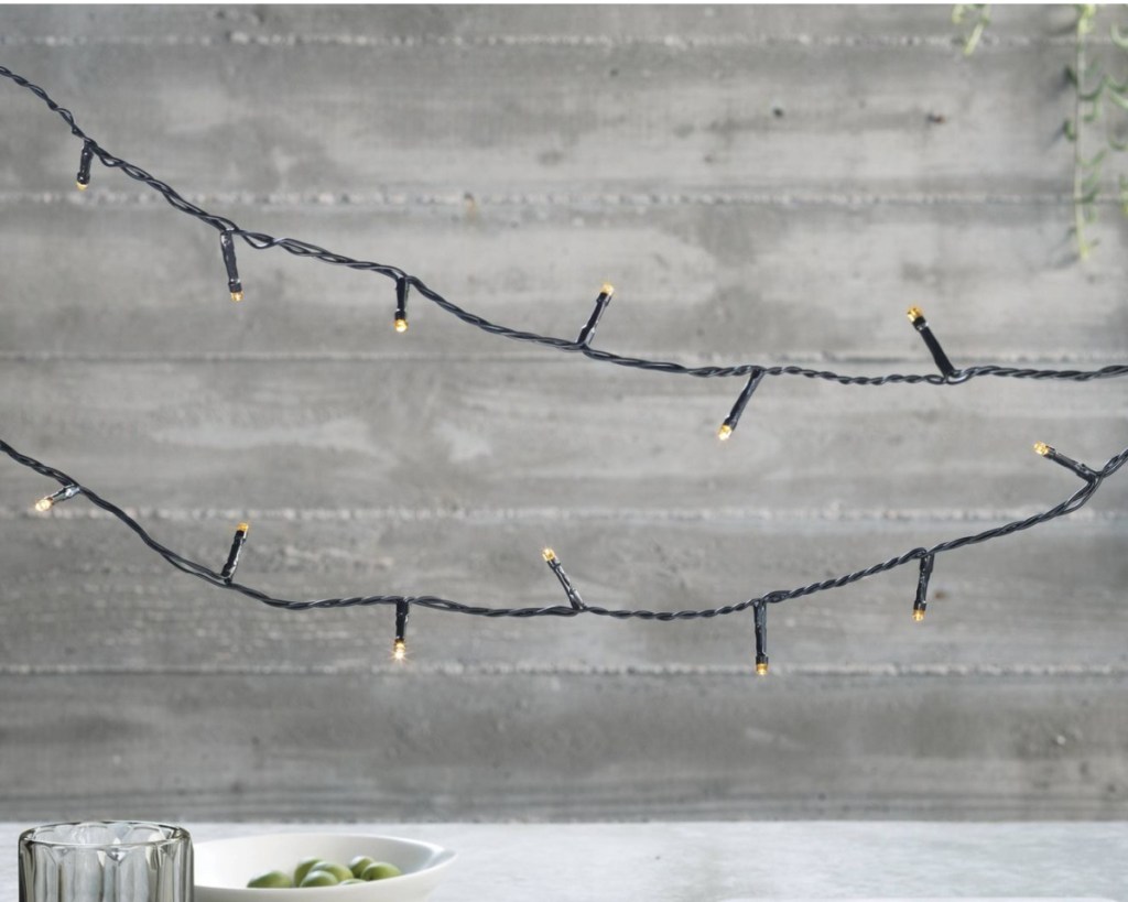 fairy lights near cement wall