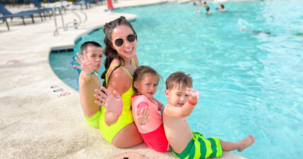 family sitting near pool at wolf lodge