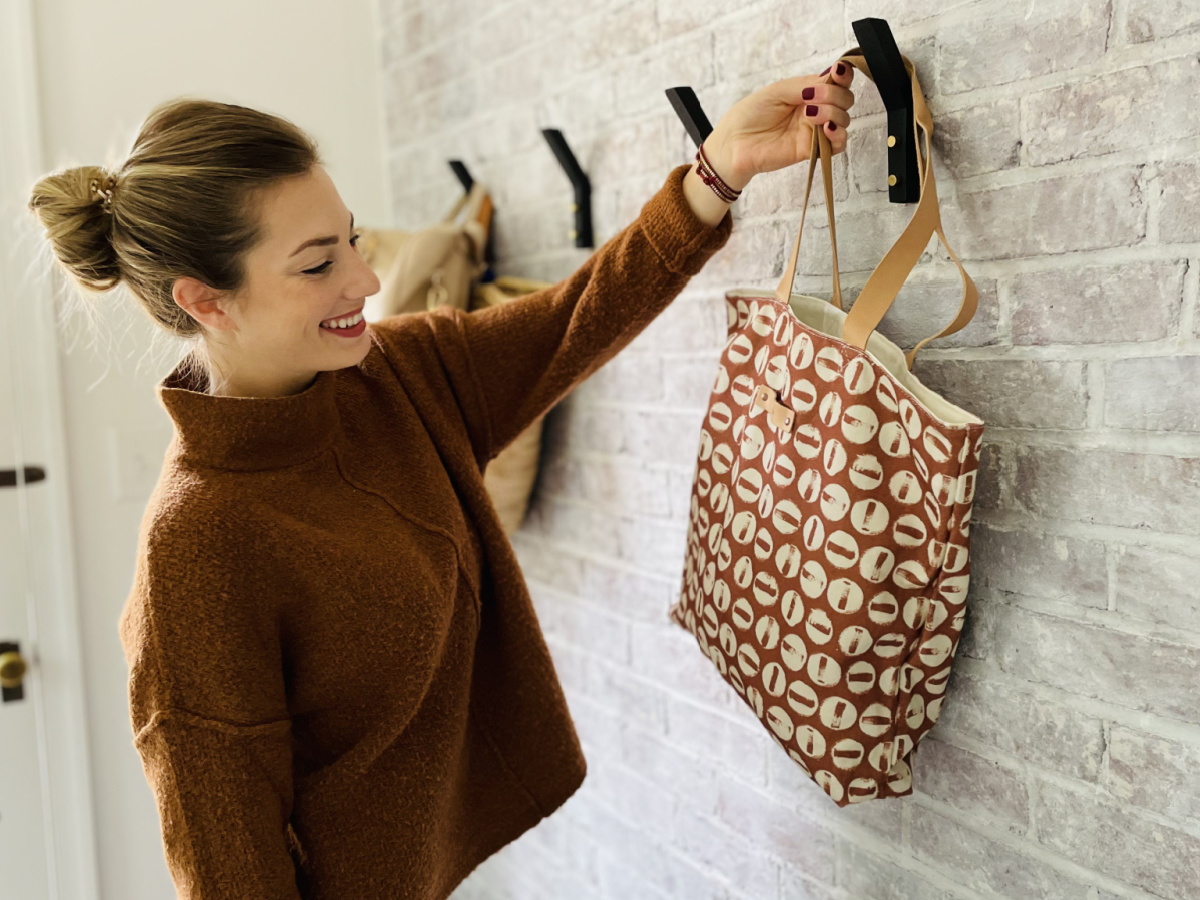 woman hanging bag on hook