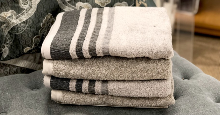 four towels stacked up on couch