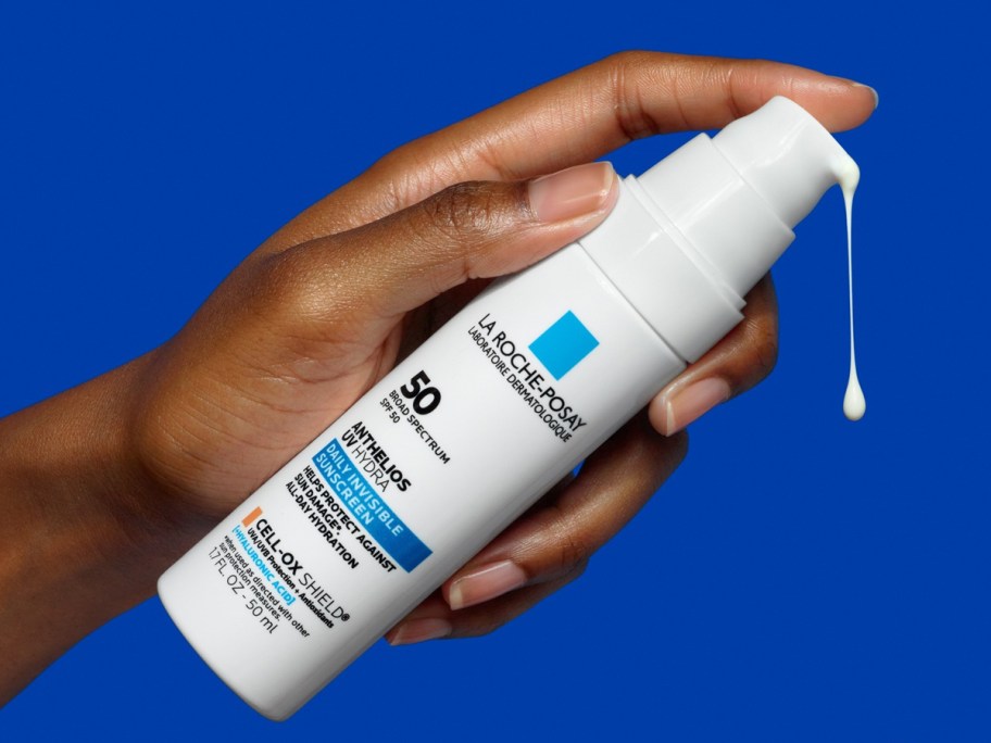 hand pumping a bottle of La Roche-Posay Anthelios UV Correct Anti-Aging Face Sunscreen