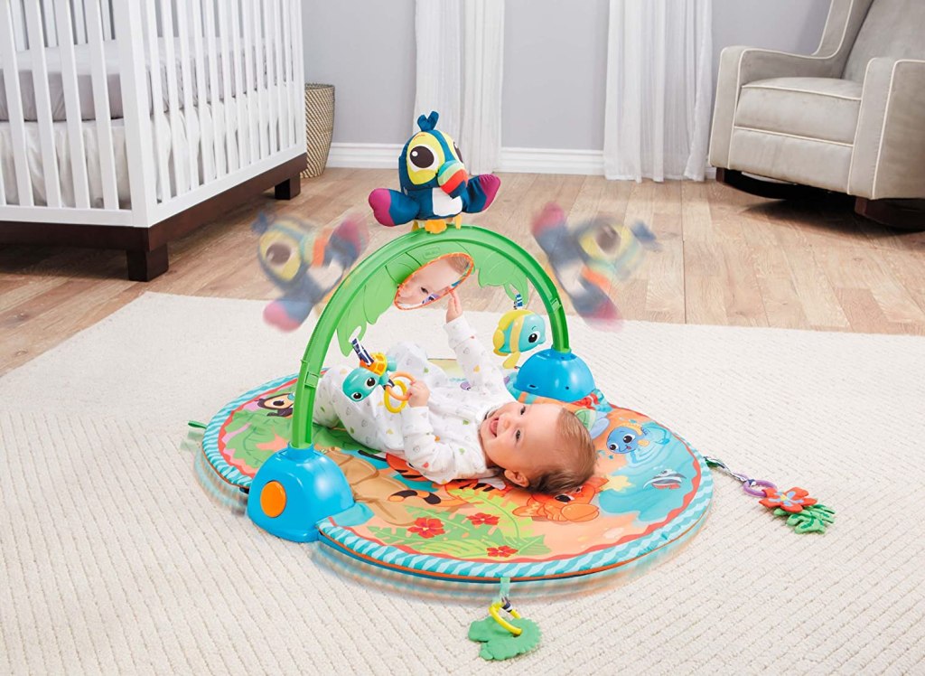 Baby playing in Little Tikes Activity Gym