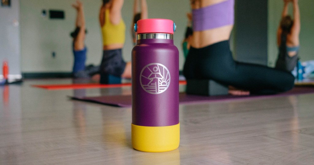 purple water bottle on floor during yoga class