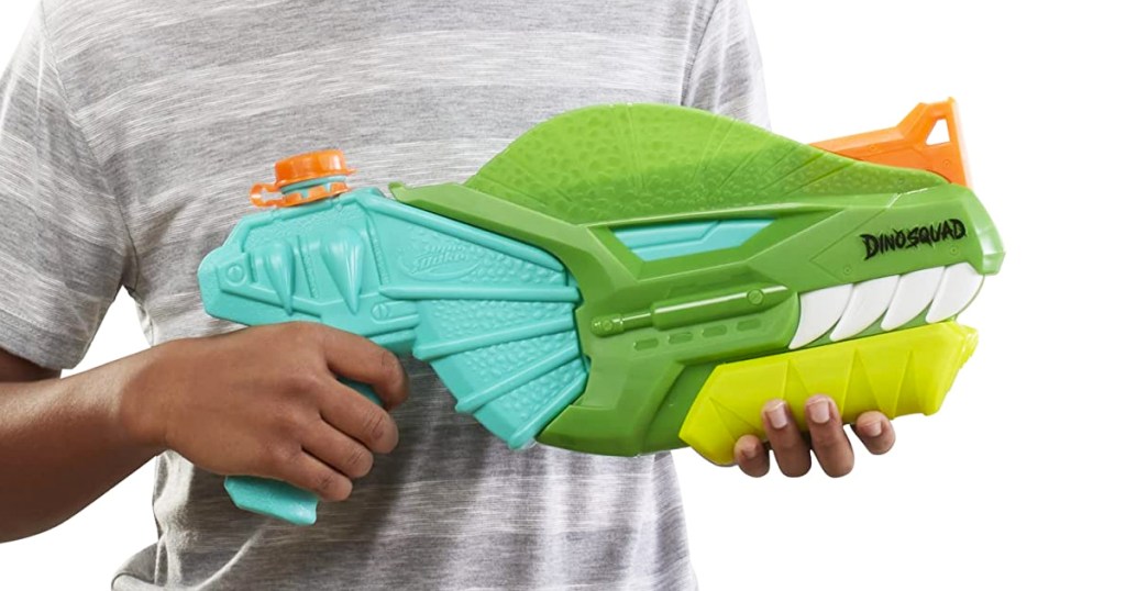 kid holding a dinosaur shaped nerf water blaster