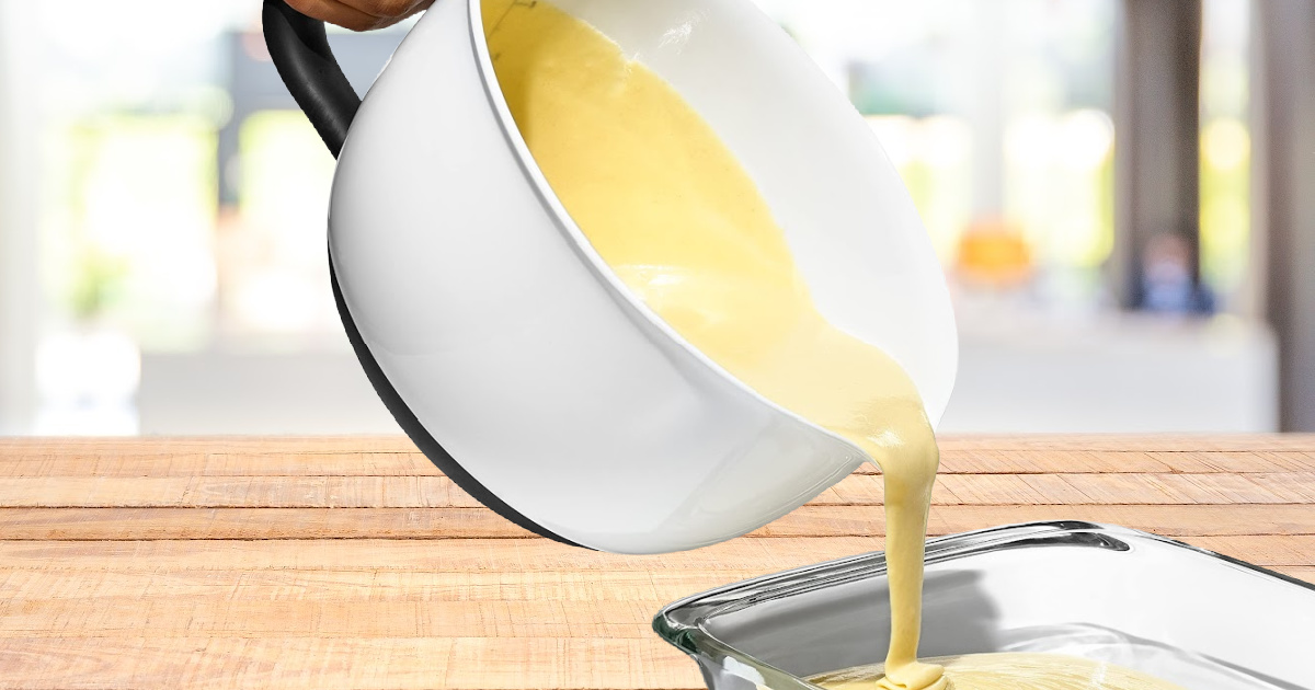 hand pouring batter in mixing bowl into glass pan