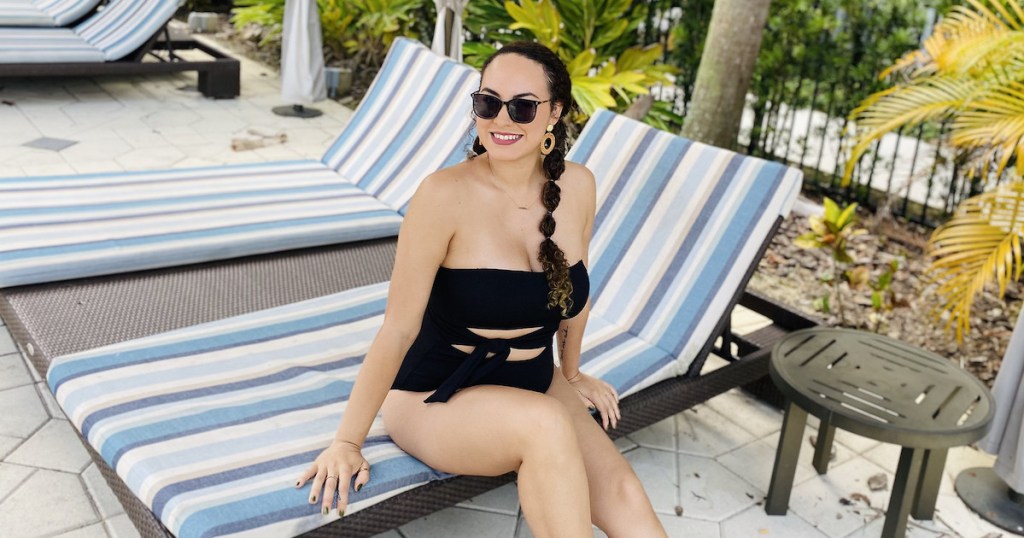 woman in modest swimwear sitting on edge of lounge chair