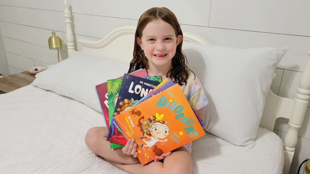 girl holding Beans and Sparks Books