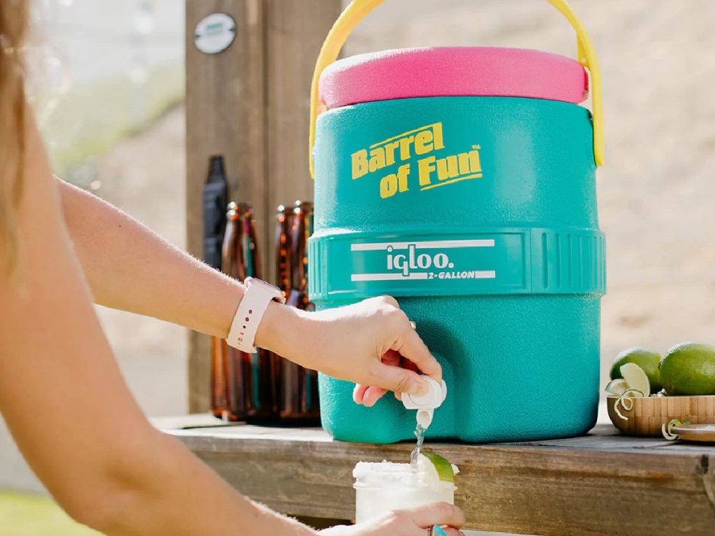 pouring drink from large green and pink Igloo retro jug