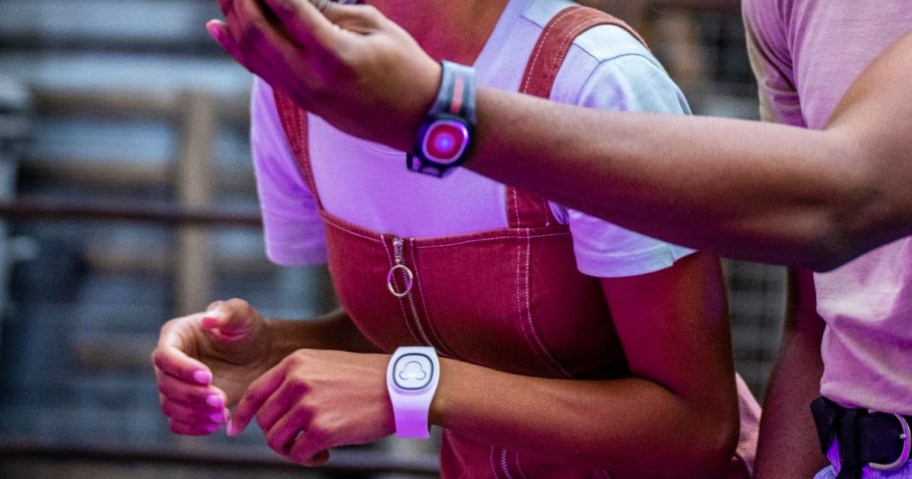 two people wearing disney magicbands