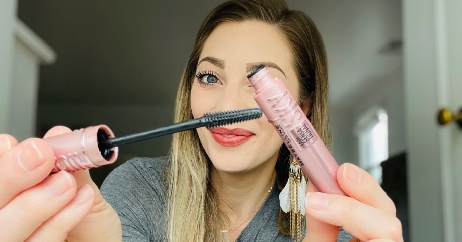 woman holding opened tube of Maybelline Sky High Mascara