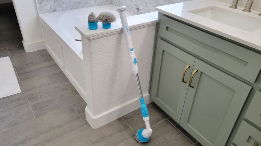 Oraimo Scrubber and brush heads leaning against wall in bathroom