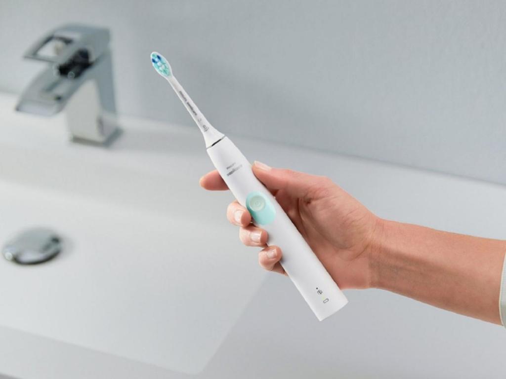 Hand holding a Philips Sonicare ProtectiveClean 4100 Rechargeable Toothbrush