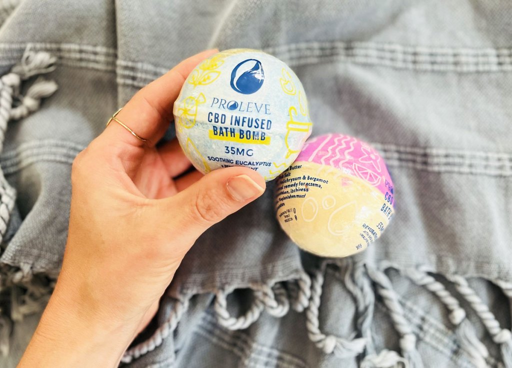hand holding a blue bath bomb