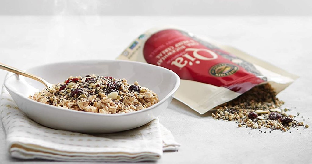 Qi'a superfood cereal in a bowl with a spoon next to a bag of Qi'a superfood cereal